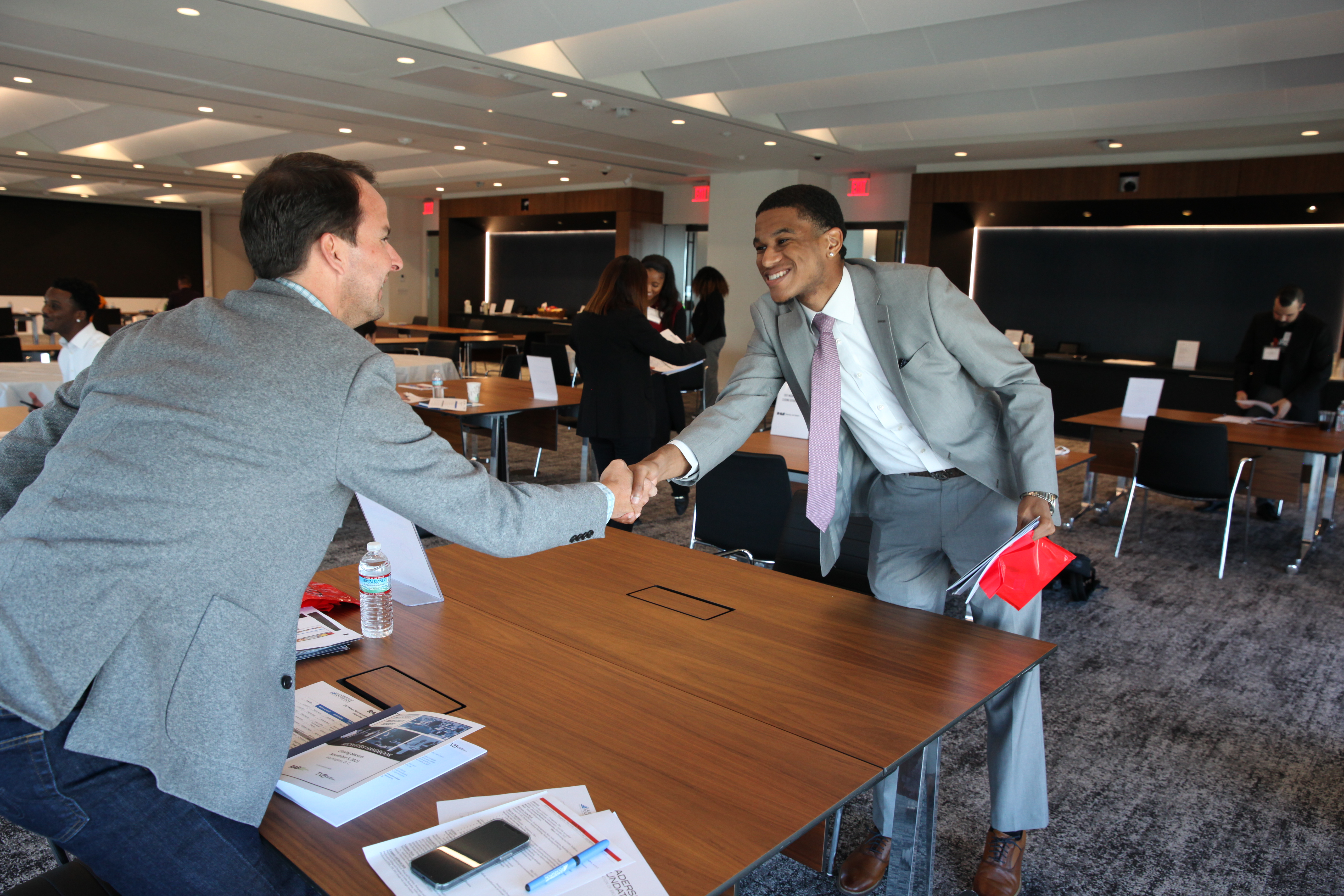 Interviewer and interviewee shaking hands at the career fair.